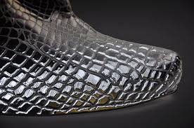Silver raised-varnish reptile-skin texture sample demonstrating high-build 3D varnish capabilities