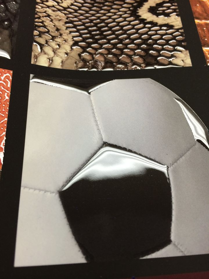 Textured print sample featuring reptile-skin effects and a raised 3D-varnish soccer ball graphic