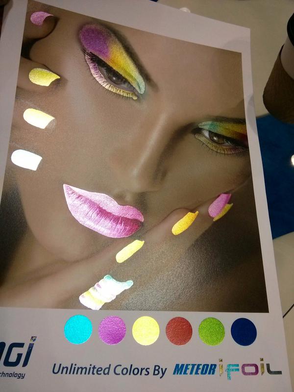 High-quality cosmetic print sample showing metallic foil effects on a model’s face and color swatches.