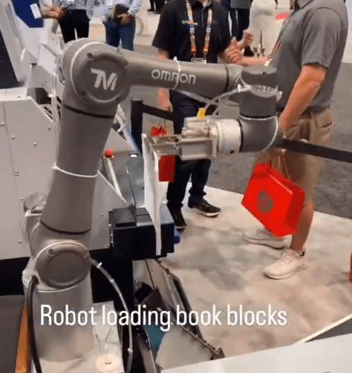 Robotic arm loading book blocks into a Horizon BQ-270 Perfect Binder