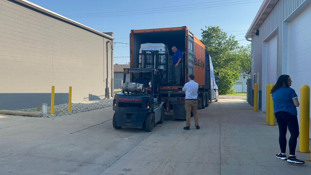Skids of Planatol Planamelt Pro being unloaded at Mid-State Litho