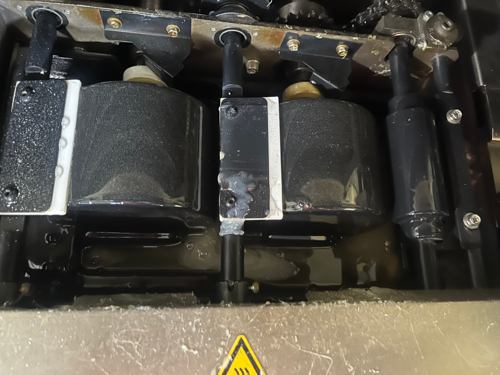 Glue pot on perfect binder being changed out to planatol planamelt pro adhesive